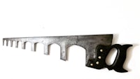 a large saw blade hanging on a wall